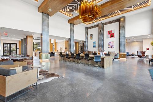 a lobby with desks and chairs in a building at Stylish 1BR Retreat in Houstons Sawyer Yard Art District Minutes to Downtown in Houston