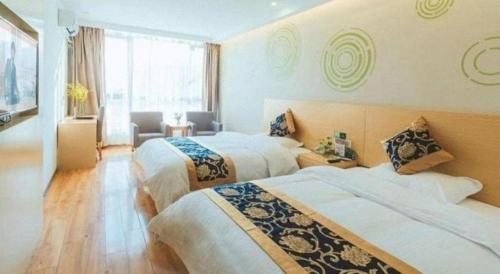 a hotel room with two beds and a window at Green Tree Inn Fengxian New City Metro Station Jiukeshu Art Center in Shanghai