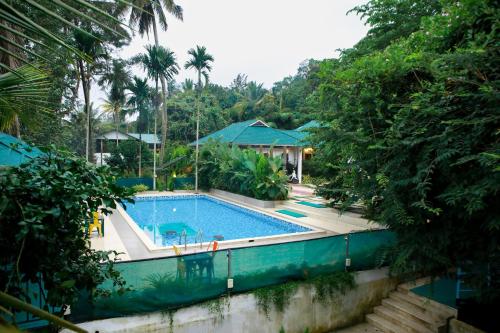 a swimming pool in the middle of a resort at BOB Green House in Sultan Bathery