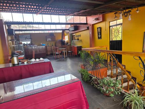 a room with a restaurant with a table and chairs at All Sur cusco in Cusco