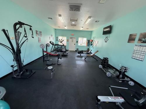 a gym with several treadmills and machines in a room at Park Model Home 268 at Silverview RV Resort in Bullhead City