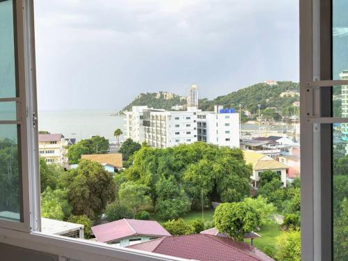 a view of a city from a window at Sea View and Hill View Room for 6 Guests, Bangsaen Royal Beach by Cozy Corner in Ban Laem Thaen