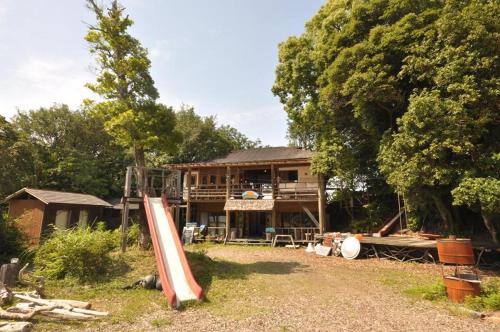 a house with a play structure in front of it at Yamamizuki in Shimanto