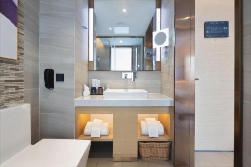 a bathroom with a sink and a mirror at Lavande Hotel Guangzhou Quzhuang Metro Station in Guangzhou