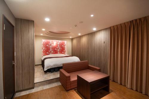 a bedroom with a bed and a window at Hotel S in Nara