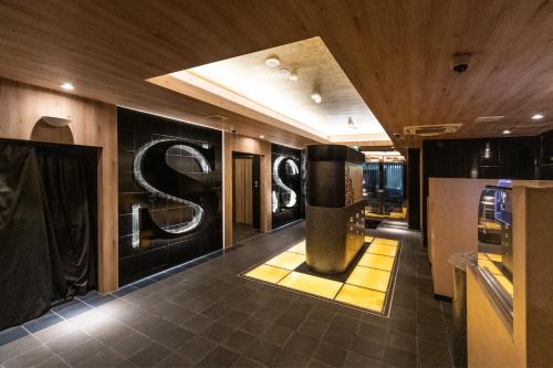 a store lobby with a s sign on the wall at Hotel S in Nara