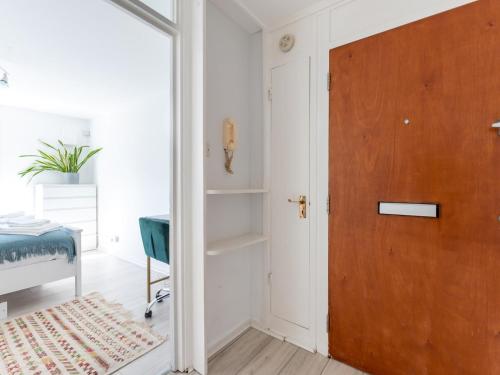 a wooden door in a room with a bedroom at Pass the Keys Charming Tranquil 2 BR Kingston Escape London in Kingston upon Thames