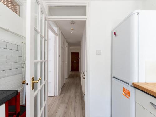 a hallway with white walls and a white door at Pass the Keys Charming Tranquil 2 BR Kingston Escape London in Kingston upon Thames