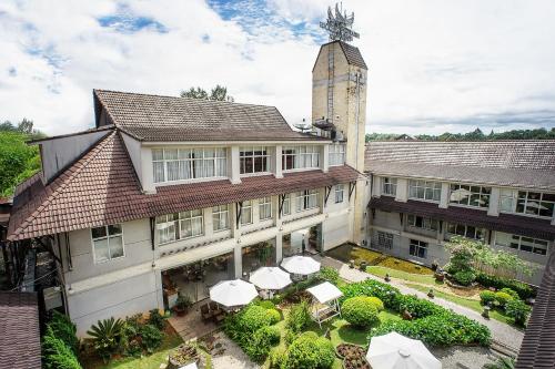 a large white building with a clock tower at Muong Thanh Holiday Da Lat Hotel in Da Lat