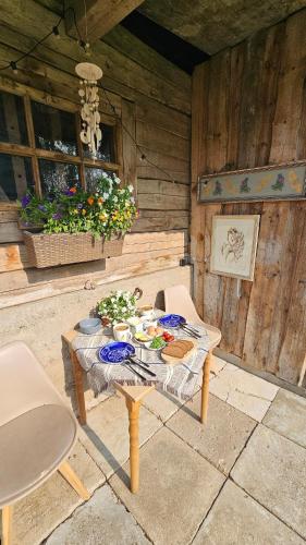 a table with food on it in a patio at Mājīgs dzīvoklis netālu no jūras in Skulte