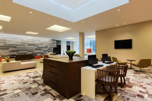 an office lobby with a desk and chairs at Hyatt Place Shenzhen Dongmen in Shenzhen
