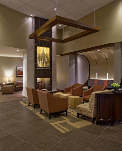 a lobby of a hotel with chairs and a fireplace at Hyatt Place Shenzhen Dongmen in Shenzhen