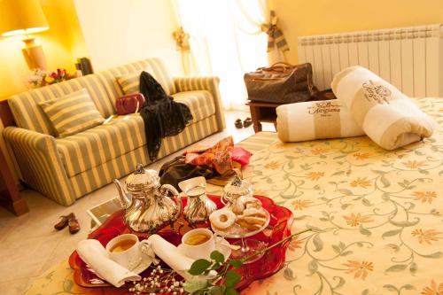 a living room with a bed with a tray of food at Hotel Astigiana & Appartamenti in Varazze