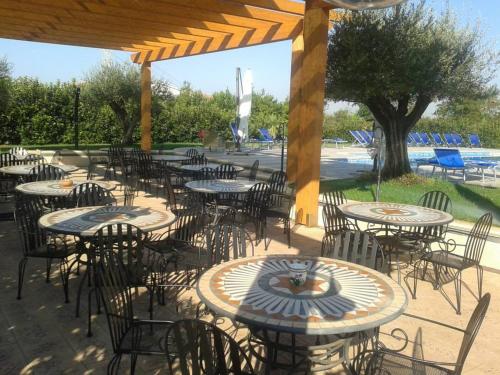 a group of tables and chairs in a patio at Hotel Villa Aurora in Latina