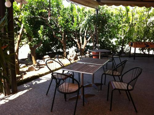 a wooden table and chairs under an umbrella at Hotel da Filie' in Querceta