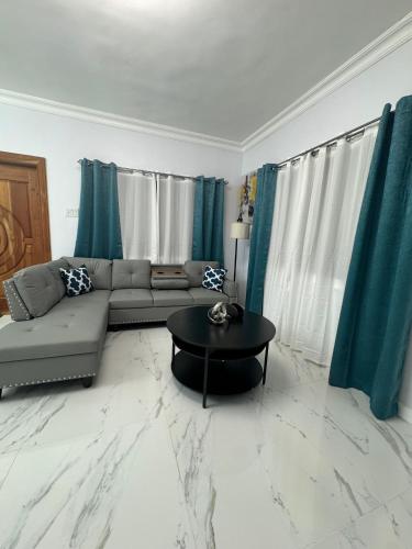 a living room with a couch and a table at Luxury Haven- Near AC Marriott Hotel Kingston in Kingston
