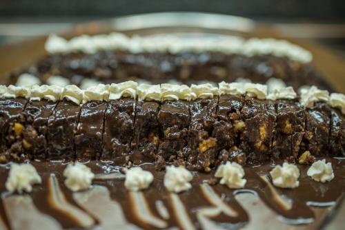 a chocolate cake with whipped cream on top of it at Astir Palace Hotel in Laganas