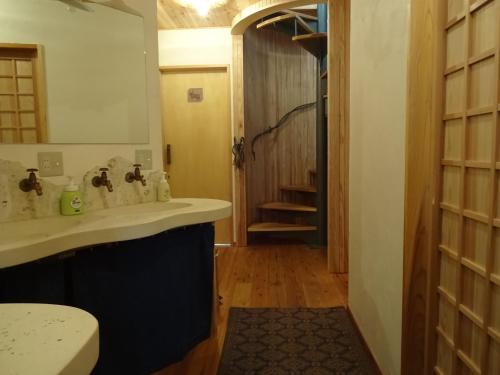 a bathroom with a sink and a mirror at Twin Dome Ryugu in Hokuto
