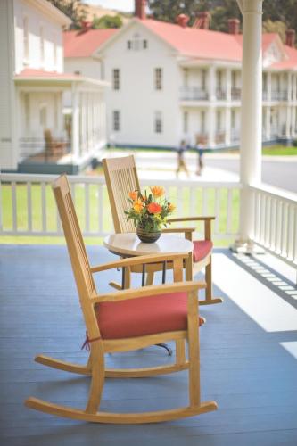 two chairs and a table with flowers on a porch at Cavallo Point in Sausalito