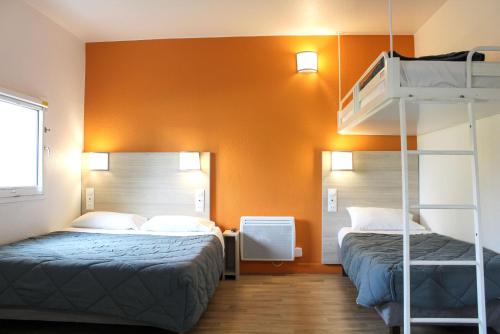 a bedroom with two beds and a bunk bed at Première Classe Plaisir Gatines in Plaisir