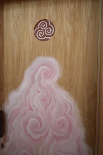 a painting of a pink swirl on a wooden door at Twin Dome Ryugu in Hokuto