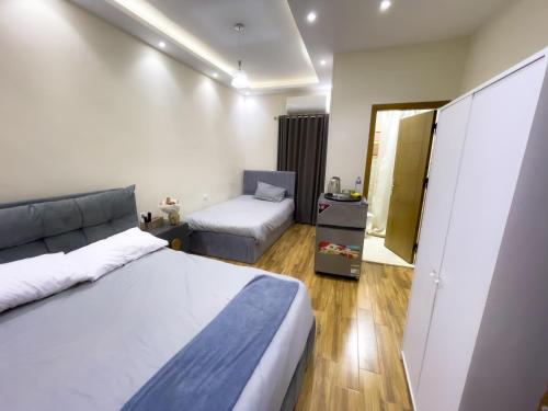 a bedroom with a bed and a couch and a mirror at Kemet Pyramids INN in Cairo