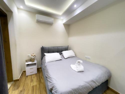 a bedroom with a bed with white sheets and white pillows at Kemet Pyramids INN in Cairo