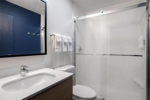 a white bathroom with a sink and a shower at Spark by Hilton Carlisle South in Carlisle