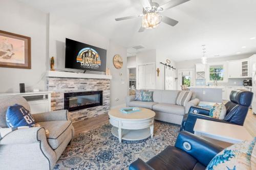 a living room with a couch and a fireplace at Fruitcakes- Private Pool- Hot Tub- Pet Friendly in St. George Island
