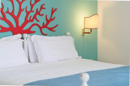 a bedroom with a bed with a red octopus on the wall at Sunbay Park Hotel in Civitavecchia