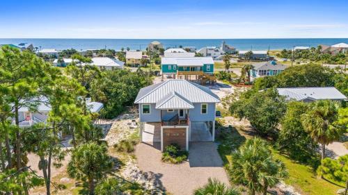 an aerial view of a house with the ocean in the background at Fruitcakes- Private Pool- Hot Tub- Pet Friendly in St. George Island