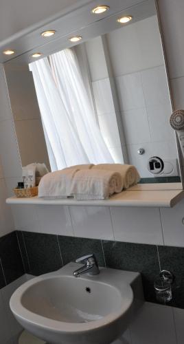 a bathroom with a sink and a mirror at Albergo Della Corona in Binasco