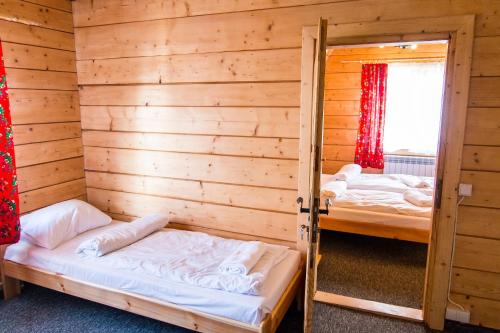 A bed or beds in a room at Willa pod Granią