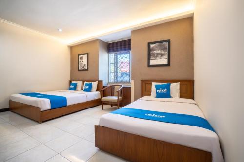 Postel nebo postele na pokoji v ubytování Rehat at Hotel 10 Buah Batu