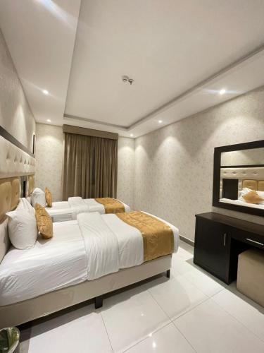 a hotel room with a large bed and a mirror at Best night hotel in Taif