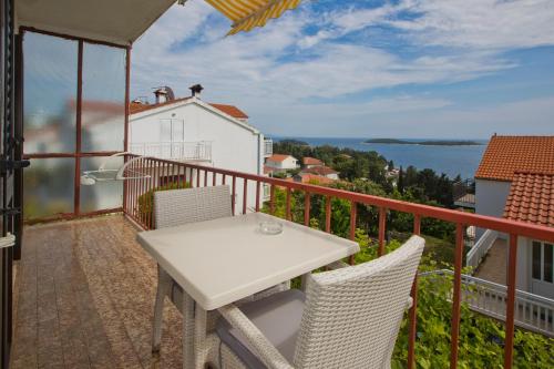 a balcony with a table and chairs and a view of the water at Apartments Vucetic in Hvar