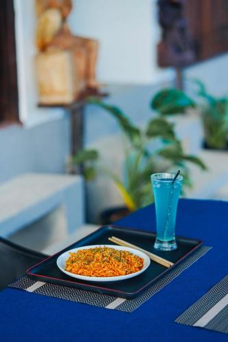 a plate of food on a table with a glass at Ramya Ru Nature Resort in Galle