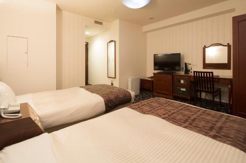 Un ou plusieurs lits dans un hébergement de l'établissement Premier Hotel-CABIN-Sapporo