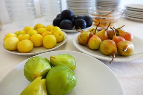 three plates of fruit on a table with plates of fruit at Masseria Carignani in Tuglie