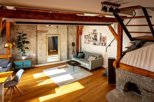 a living room with a couch and a fireplace at Studio Loft Murau - im Herzen der Altstadt in Murau