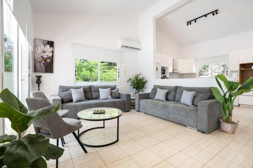 a living room with two couches and a table at Villa Adela Coral-Bay 3B, Private Pool, Seaside in Peyia