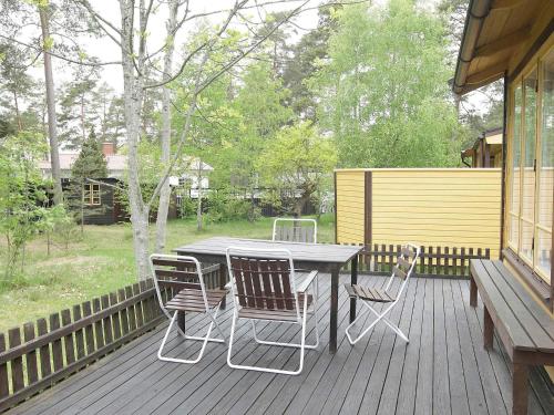 a patio with a table and chairs on a deck at 4 person holiday home in Mönsterås-By Traum in Mönsterås