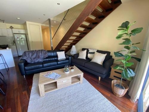 a living room with a couch and a coffee table at Halls Gap Escape Townhouses in Halls Gap