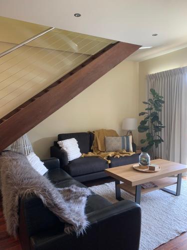 a living room with a couch and a table at Halls Gap Escape Townhouses in Halls Gap