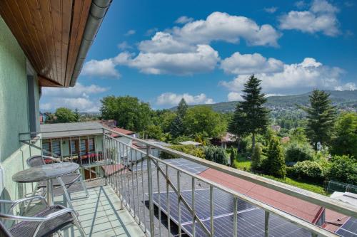 a balcony with chairs and a view of the mountains at Villa Vlasta in Karlovy Vary