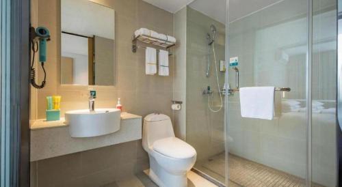 a bathroom with a toilet and a sink and a shower at City Comfort Inn Dangtu High Speed East Railway Station RT-Mart in Ma'anshan