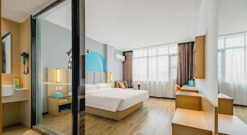 a bedroom with a white bed and a large window at City Comfort Inn Dangtu High Speed East Railway Station RT-Mart in Ma'anshan