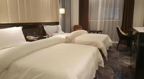 a hotel room with three beds with white sheets at Jinjiang Metropolo Hotel Nanjing Confucius Temple Branch in Nanjing