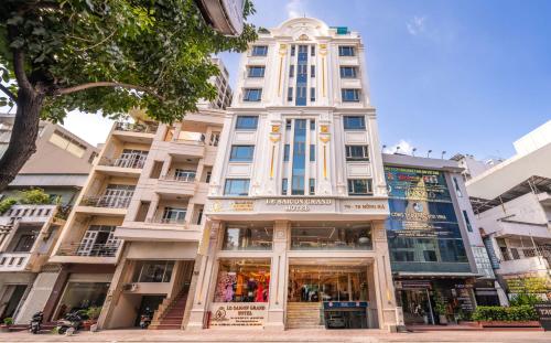 a tall white building with a store front at Le Saigon Grand Hotel in Ho Chi Minh City