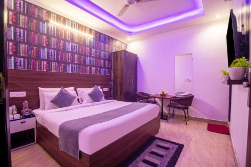 a bedroom with a large bed and a table at HOTEL S R Palace - Free Airport Drop for Minimum 05 Nights Stay - 5 mins from IGI & Domestic Airport Delhi in New Delhi
